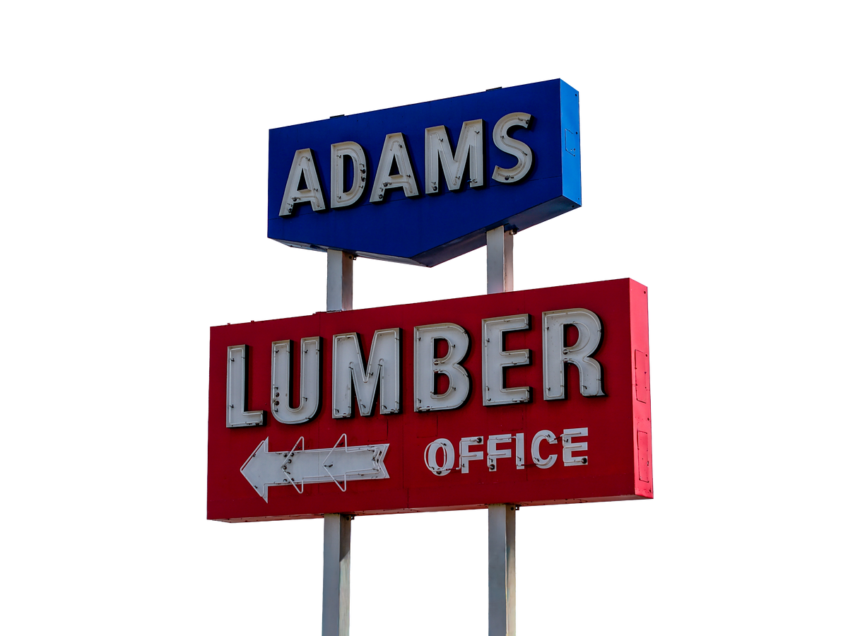 Adams Lumber sign photographed in daylight and isolated for commercial design